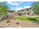 Landscaped backyard with a lawn, gravel beds, and mature trees at 14161 W Poinsettia Dr, Surprise, AZ 85379
