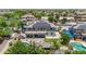 An aerial shot displays the home's backyard featuring a pool, patio, and well-manicured lawn at 14161 W Poinsettia Dr, Surprise, AZ 85379