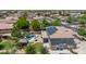 An aerial view showcasing the backyard pool, patio, and solar panels of this home at 14161 W Poinsettia Dr, Surprise, AZ 85379