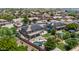 This aerial view captures the backyard's pool, covered patio, and lush green landscaping at 14161 W Poinsettia Dr, Surprise, AZ 85379