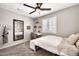 Bedroom featuring a white desk, natural lighting, and a mirror at 14161 W Poinsettia Dr, Surprise, AZ 85379