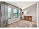 Inviting bedroom with neutral walls, a wooden dresser, and large windows for plenty of natural light at 14161 W Poinsettia Dr, Surprise, AZ 85379