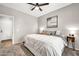Neutral bedroom featuring a ceiling fan, cozy carpet, and stylish bedding at 14161 W Poinsettia Dr, Surprise, AZ 85379
