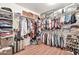 Spacious walk-in closet with custom shelving, providing ample storage for clothes, shoes, and accessories at 14161 W Poinsettia Dr, Surprise, AZ 85379