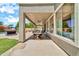 Spacious covered patio with dining area, ceiling fans, and backyard views at 14161 W Poinsettia Dr, Surprise, AZ 85379