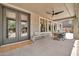 Relaxing covered patio with outdoor seating, ceiling fan, and natural light at 14161 W Poinsettia Dr, Surprise, AZ 85379