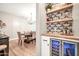 Inviting dining area featuring a wine fridge and a view into the stylish dining room at 14161 W Poinsettia Dr, Surprise, AZ 85379