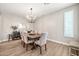 Bright dining room with modern lighting, neutral colors, and wood flooring at 14161 W Poinsettia Dr, Surprise, AZ 85379