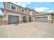Elegant two-story home boasting a three-car garage, neutral colors, and a paved driveway at 14161 W Poinsettia Dr, Surprise, AZ 85379