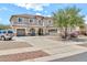 Beautiful two-story home with a circular driveway, three-car garage, and well-maintained landscaping at 14161 W Poinsettia Dr, Surprise, AZ 85379