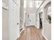 Bright foyer featuring wood-look flooring, high ceilings, and a modern design at 14161 W Poinsettia Dr, Surprise, AZ 85379
