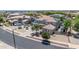 Aerial view of the front exterior shows a well-manicured lawn and desert landscaping at 14161 W Poinsettia Dr, Surprise, AZ 85379