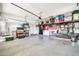Spacious garage with overhead storage, sink, and room for projects at 14161 W Poinsettia Dr, Surprise, AZ 85379