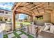 Outdoor gazebo with seating, a television, and backyard views at 14161 W Poinsettia Dr, Surprise, AZ 85379