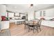 Large open kitchen and dining area with an island and white cabinetry at 14161 W Poinsettia Dr, Surprise, AZ 85379
