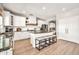 Spacious kitchen with granite counters, white cabinets, and a large central island at 14161 W Poinsettia Dr, Surprise, AZ 85379