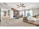 Expansive primary bedroom featuring a reclaimed wood accent wall and a cozy sitting area at 14161 W Poinsettia Dr, Surprise, AZ 85379