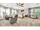 Spacious main bedroom with ample natural light, ceiling fan, and cozy seating at 14161 W Poinsettia Dr, Surprise, AZ 85379