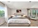 Inviting bedroom featuring a comfortable bed, a window with tree views, and ambient side table lamps at 14161 W Poinsettia Dr, Surprise, AZ 85379