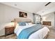 Comfortable bedroom with a large bed, soft blue accents, and stylish wooden nightstands at 14161 W Poinsettia Dr, Surprise, AZ 85379