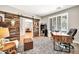 Home office boasts custom barn doors and offers a quiet, private workspace at 14161 W Poinsettia Dr, Surprise, AZ 85379