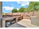 Outdoor kitchen features a built-in grill, prep area, and patio space at 14161 W Poinsettia Dr, Surprise, AZ 85379