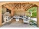 Cozy covered patio featuring comfortable seating, a modern fire pit, and stylish decor at 14161 W Poinsettia Dr, Surprise, AZ 85379