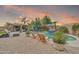 Beautiful pool area with lounge chairs, cabana, and lush landscaping perfect for outdoor entertaining at 14161 W Poinsettia Dr, Surprise, AZ 85379