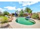 Sparkling pool with lounge chairs, lush landscaping, and a charming cabana for relaxing outdoors at 14161 W Poinsettia Dr, Surprise, AZ 85379