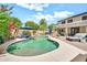 Backyard pool features comfortable lounge seating and beautiful landscaping at 14161 W Poinsettia Dr, Surprise, AZ 85379