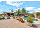 Inviting pool area with lounge chairs, manicured landscaping, and patio for outdoor enjoyment at 14161 W Poinsettia Dr, Surprise, AZ 85379