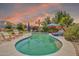 Relaxing pool area with lounge chairs, cabana, and lush landscaping for a tranquil outdoor retreat at 14161 W Poinsettia Dr, Surprise, AZ 85379