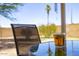 Cozy backyard setting with a glass table, chair, and a refreshing drink on a sunny day at 1454 W Capri Ave, Mesa, AZ 85202
