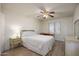 Cozy bedroom with wood floors, a comfortable bed, and natural light from the window at 1454 W Capri Ave, Mesa, AZ 85202