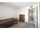 Simple bedroom with a bed, dresser, and doorway to an adjacent room at 1454 W Capri Ave, Mesa, AZ 85202