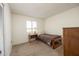 Neutral bedroom with a single bed, window for natural light, and a bedside table at 1454 W Capri Ave, Mesa, AZ 85202