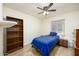 Small bedroom with a single bed, bookcase, and bedside table with a lamp at 1454 W Capri Ave, Mesa, AZ 85202