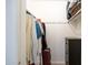 Organized walk-in closet with clothing racks, shelves, and a suitcase for storage at 1454 W Capri Ave, Mesa, AZ 85202