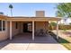 Covered patio area with a table and chairs, perfect for outdoor dining and relaxation at 1454 W Capri Ave, Mesa, AZ 85202