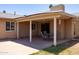 Relaxing covered patio with outdoor seating, ideal for entertaining and enjoying the backyard views at 1454 W Capri Ave, Mesa, AZ 85202