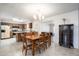 Bright dining area adjacent to kitchen with a wood table, tile floors, and chandelier at 1454 W Capri Ave, Mesa, AZ 85202