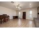 Bright living room featuring wood floors, a piano, and large windows with natural light at 1454 W Capri Ave, Mesa, AZ 85202