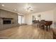 Open living room with brick fireplace and wood floors, seamlessly connecting to the dining area at 1454 W Capri Ave, Mesa, AZ 85202
