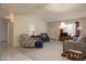 Inviting living room with open layout, showcasing the carpet, seating, and lighting fixtures at 1454 W Capri Ave, Mesa, AZ 85202