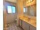 The bathroom vanity features an undermount sink, mirror, and a window for natural light at 15602 N 55Th Ave, Glendale, AZ 85306