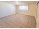 Neutral-toned bedroom with tile flooring, one window, and closet at 15602 N 55Th Ave, Glendale, AZ 85306