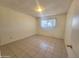 Neutral-toned bedroom featuring tile floors and natural light at 15602 N 55Th Ave, Glendale, AZ 85306