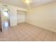 View of the bedroom showcasing the tile floor and the closet with bi-fold doors at 15602 N 55Th Ave, Glendale, AZ 85306