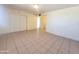 Neutral-toned bedroom with tile flooring, closet, and doorway to hallway at 15602 N 55Th Ave, Glendale, AZ 85306