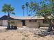 Single-story home featuring desert landscaping, mature trees, and a small gated front porch at 15602 N 55Th Ave, Glendale, AZ 85306